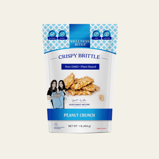 Wellness Bites Crispy Brittle Peanut Crunch plant-based snack in a resealable pouch.